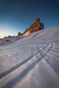 Scenic view of snowcapped mountains against clear blue sky