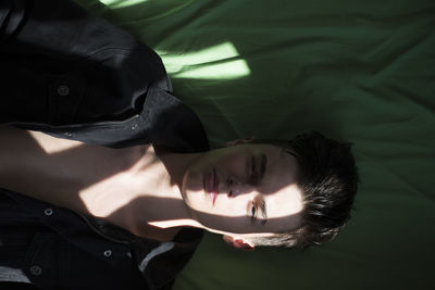 Portrait of young woman sleeping on bed