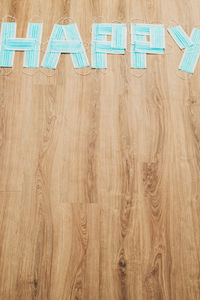 High angle view of text on hardwood floor