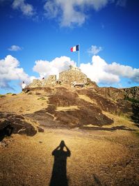 Shadow of man on mountain against sky