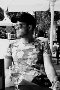 Young man sitting on table at restaurant