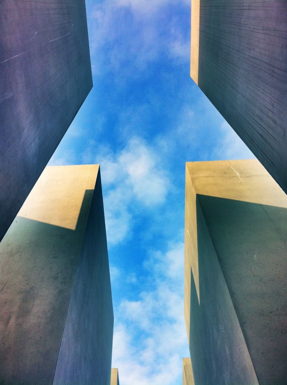 architecture, building exterior, built structure, low angle view, sky, building, city, cloud - sky, tower, office building, cloud, modern, tall - high, skyscraper, outdoors, day, no people, cloudy, window, residential structure