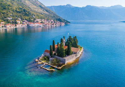 High angle view of sea by buildings against sky