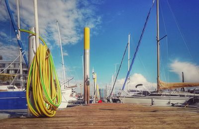 Sailboats in sea against sky