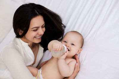 Close-up of mother carrying daughter at home