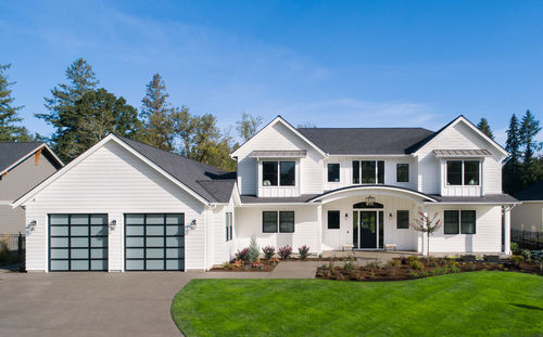 Beautiful modern farmhouse style luxury home exterior with blue sky