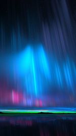 Blurred motion of illuminated fireworks against sky at night