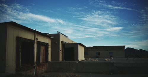 Buildings against cloudy sky