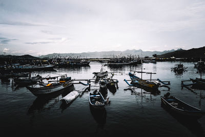 Boats moored in lake against sky