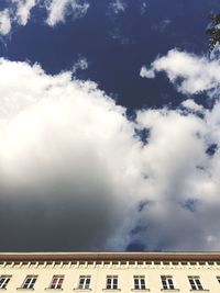 Low angle view of building against cloudy sky