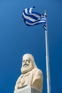 Low angle view of statue against blue sky