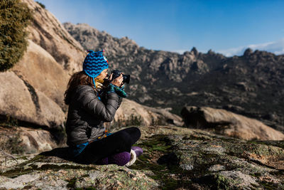 Woman sitting on rock