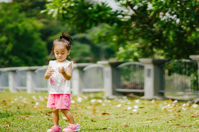 Full length of cute girl in grass