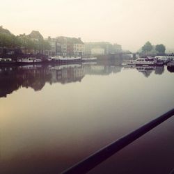 Boats in river with buildings in background