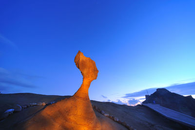 Scenic view of desert against clear blue sky