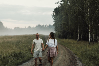 Couple walking on dirt road