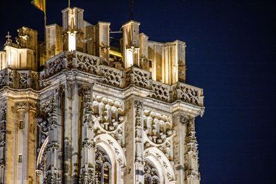 Low angle view of building against clear sky at night