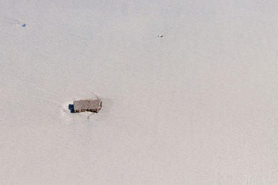 High angle view of telephone on snow covered land