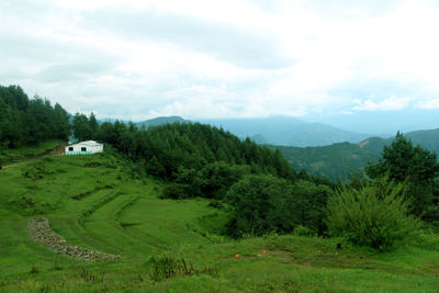 Scenic view of landscape against cloudy sky