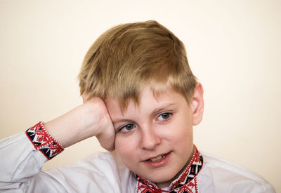 Close-up portrait of boy against white background