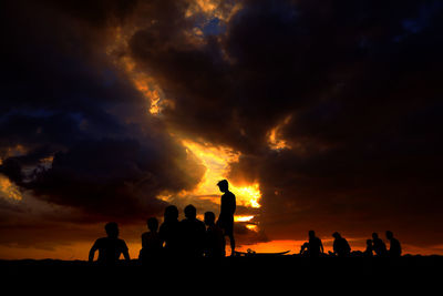 Silhouette of people at sunset