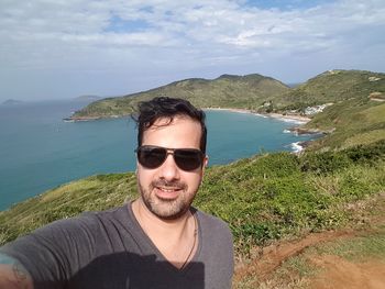 Young man by sea on mountain