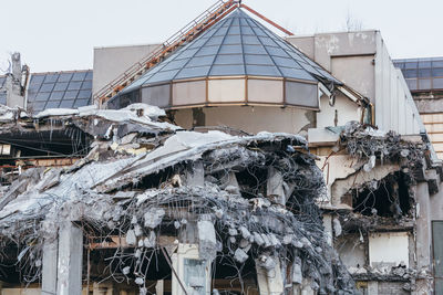 Photo of destroyed building, protruding reinforcement. demolition of a building, house ruins