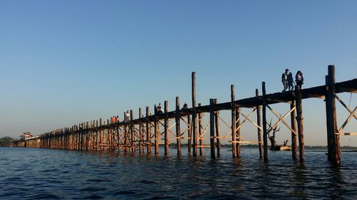 Pier on sea at sunset