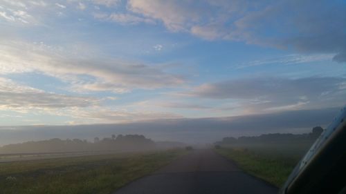 Road amidst landscape against sky during sunset