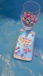 Mobile phone covered in colored chocolates 