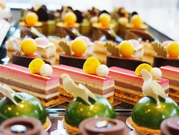 Close-up of garnished sweet cakes arranged in order