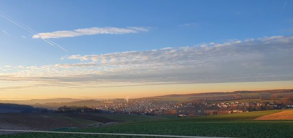 Scenic view of field against sky during sunset