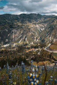 High angle view of land and mountains against sky