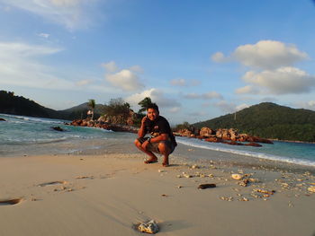 A boy play at beach with crystal clear water at marine park redang, malaysia