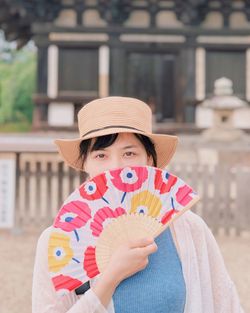 Portrait of cute girl holding hat