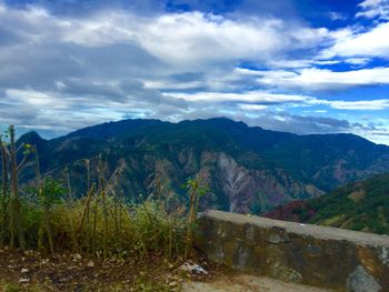 Scenic view of mountains against cloudy sky