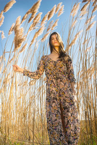 Woman standing on field against sky