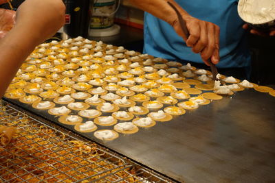 Midsection of man preparing food at restaurant