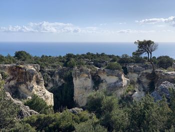 Scenic view of rocks and sea against sky