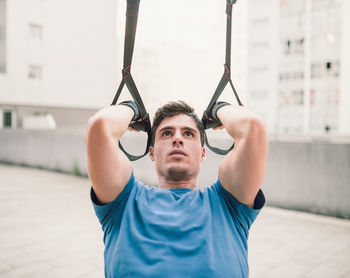 Portrait of man with arms raised