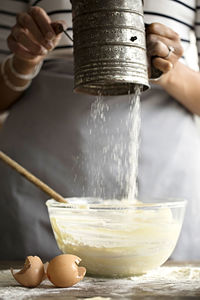 Midsection of woman preparing food in kitchen