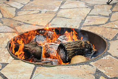 High angle view of firewood on barbecue grill