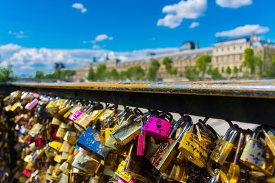 Close-up of love locks hanging by street