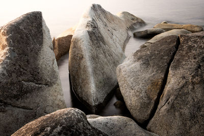 Rocks on beach against sky