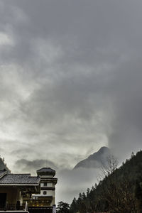 Low angle view of building against cloudy sky