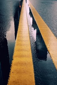 High angle view of yellow road by water