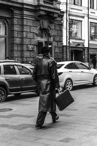 Rear view of businessman walking on city street