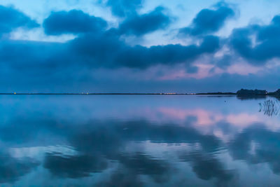 Reflection of sky on lake at dusk