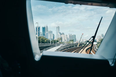 Cityscape seen through train windshield