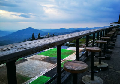 Lounge chairs and tables against sky